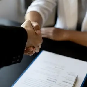 Estate Planning attorney shaking hands with a successor trustee.