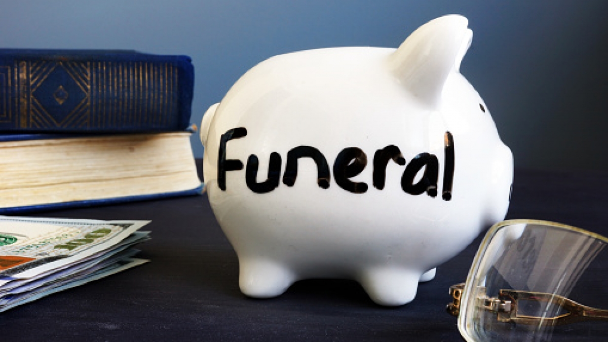 Funeral plan written on a side of piggy bank.